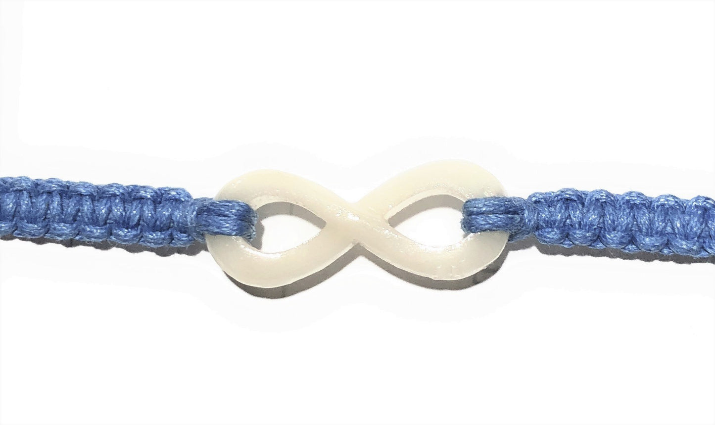 All natural Hand carved Infinity Tagua charm on a hand woven cotton bracelet by Tu y Yo