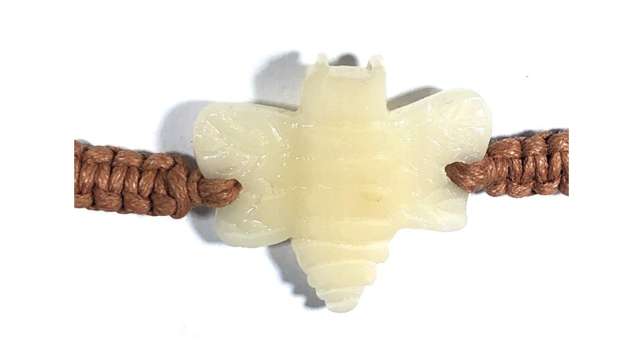 All natural Hand carved Bee Tagua charm on a hand woven cotton bracelet by Tu y Yo