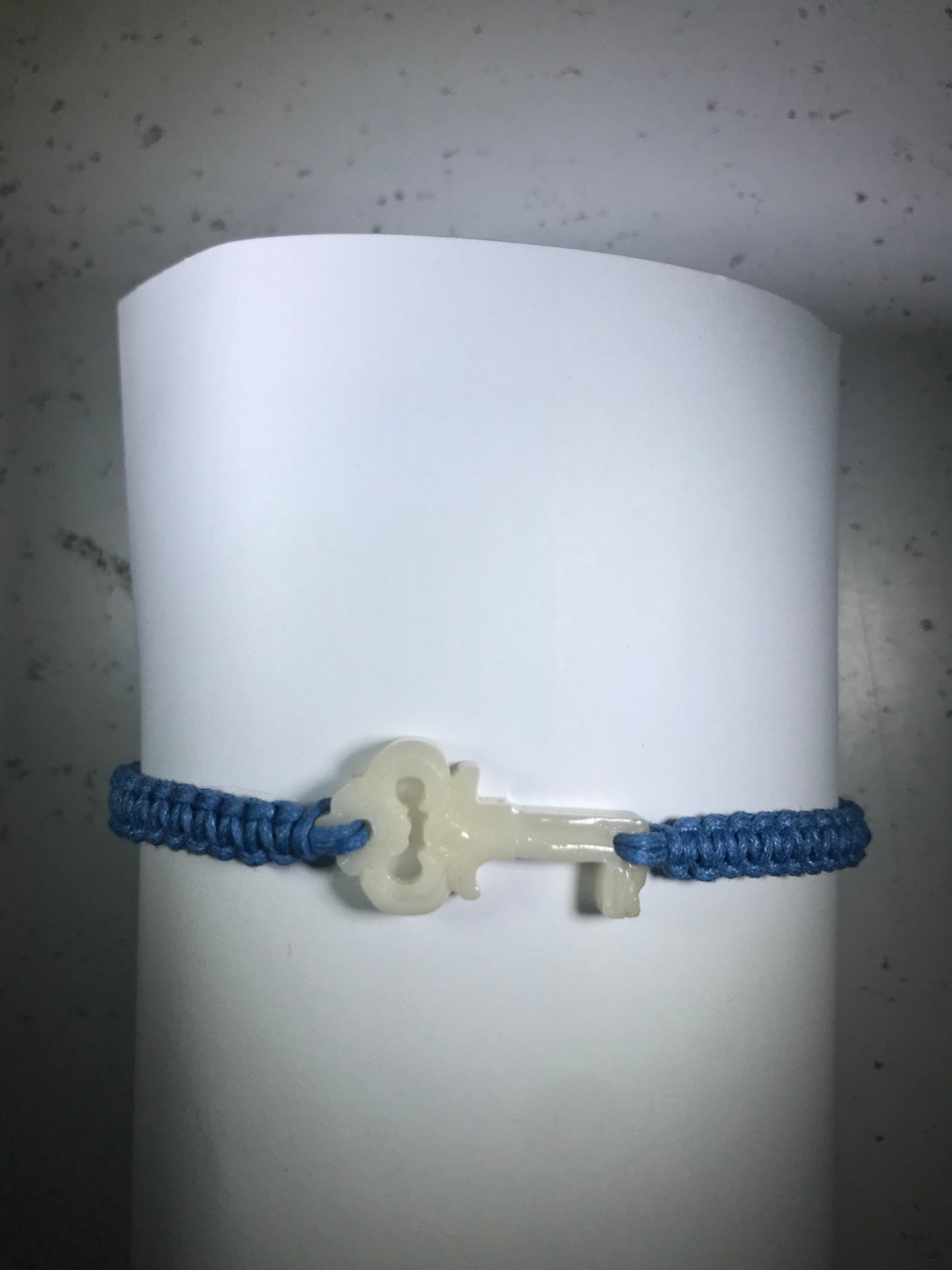All natural Hand carved Key Tagua charm on a hand woven cotton bracelet by Tu y Yo