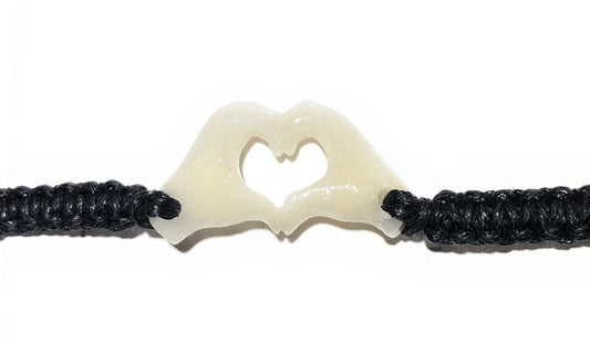 All natural Hand carved Heart In Hands Tagua charm on a hand woven cotton bracelet by Tu y Yo