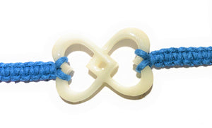 All natural Hand carved Interlocked Hearts Tagua charm on a hand woven cotton bracelet by Tu y Yo