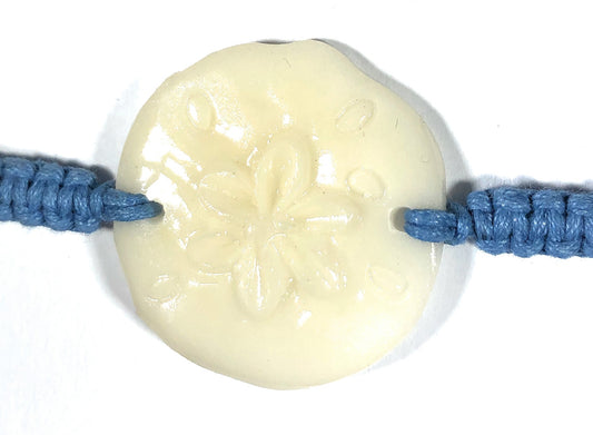 All natural Hand carved Sand Dollar Tagua charm on a hand woven cotton bracelet by Tu y Yo