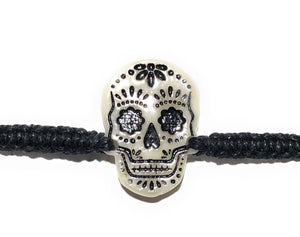 All natural Hand carved Skull Tagua charm on a hand woven cotton bracelet by Tu y Yo