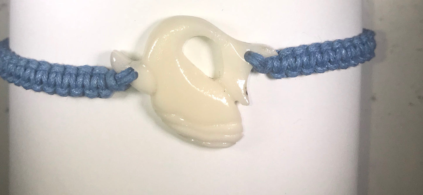 All natural Hand carved Right Whale Tagua charm on a hand woven cotton bracelet by Tu y Yo